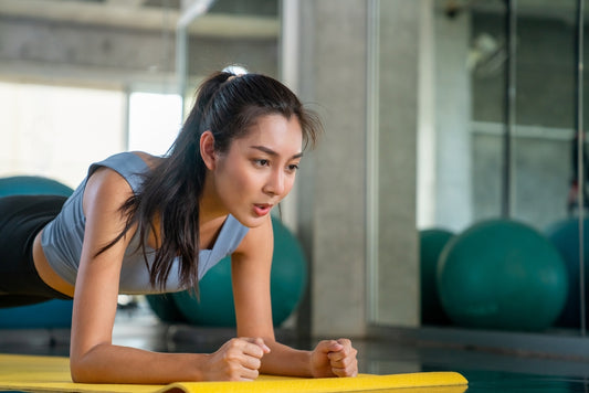 Woman planking mid exercise