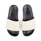 Australian designer black slides with upper in white quilted fabric.