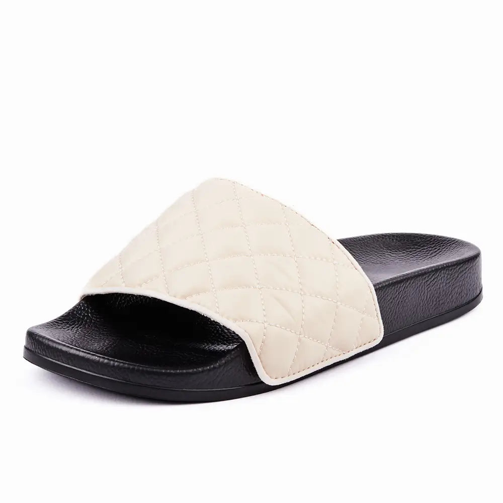 Australian designer black slides with upper in white quilted fabric.