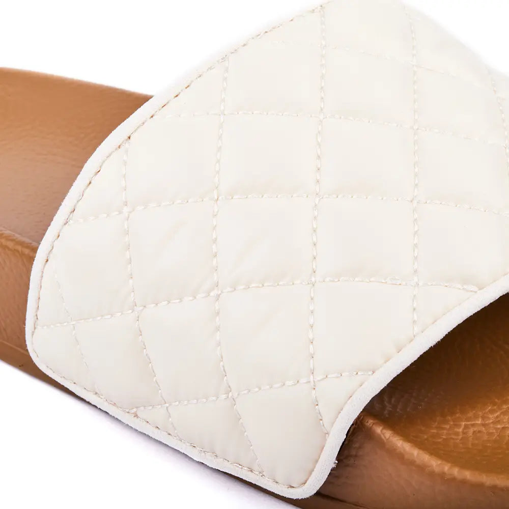 Australian designer camel slides with upper in white quilted fabric.